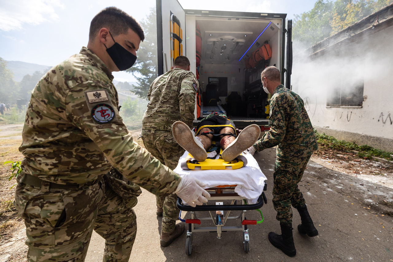 Medics from Montenegro and Bosnia and Herzegovina load a simulated casualty into an ambulance in Ohrid, North Macedonia during consequence-management exercise North Macedonia 2021.