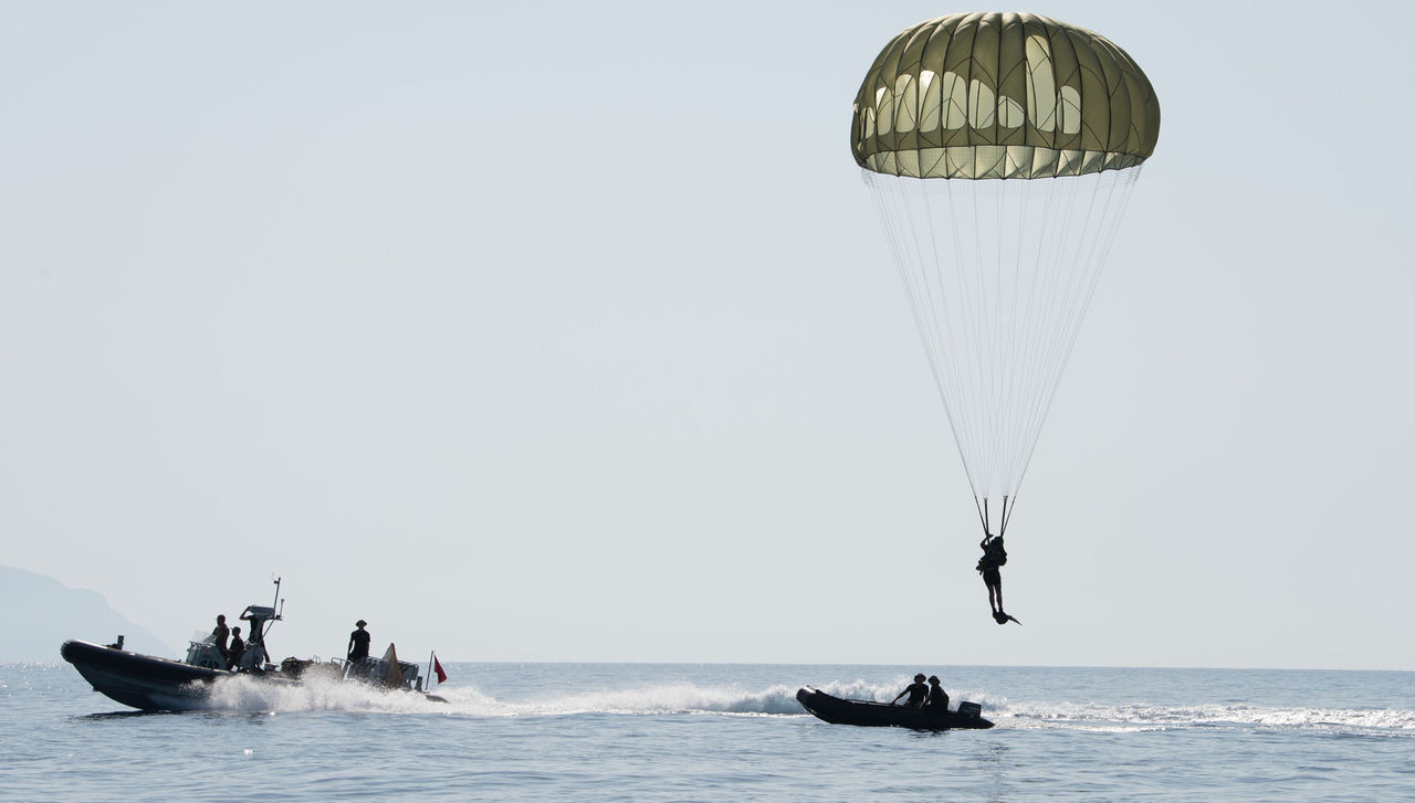 MEDITERANEAN SEA September. 16. 2017. A Turkish paratrooper    ends his jump on the water as he participates in a escaped submariner Search and Rescue (SAR) exercise during  Dynamic Monarch. NATO Photo by FRAN CPO Christian Valverde.