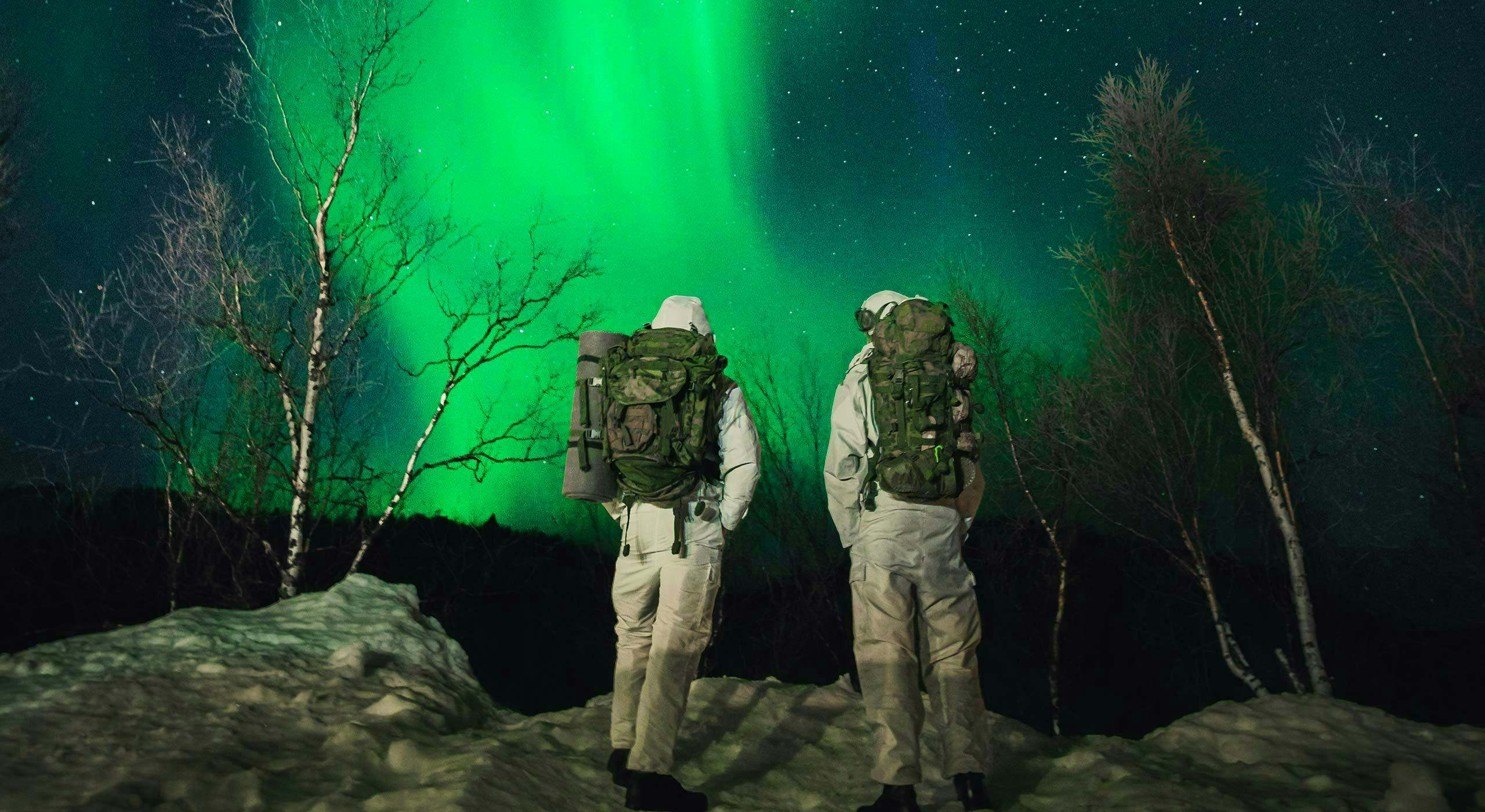 NATO soldiers observe the Northern Lights during exercise Nordic Response 24. Norway, March 2024.