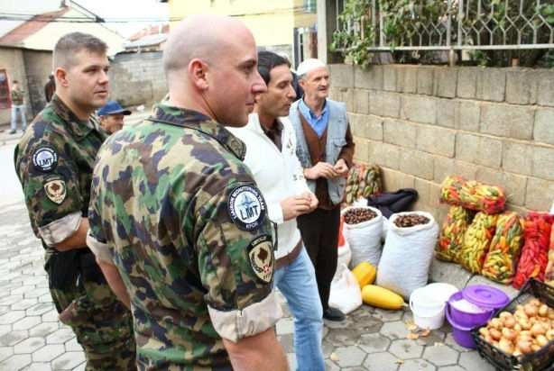 Swiss Liaison and Monitoring Team officers in contact with local residents, as part of the NATO-led Kosovo Force.