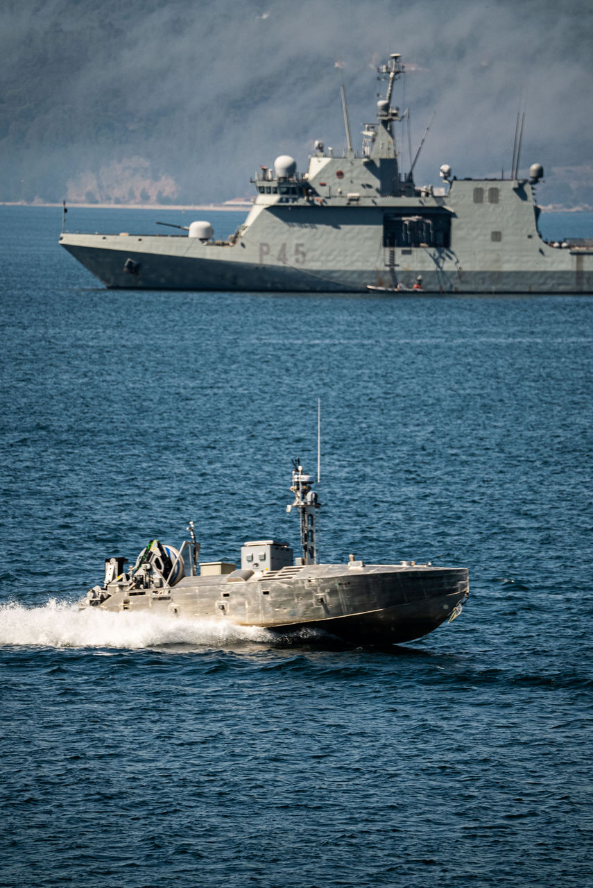 A Common Unmanned Surface Vehicle (CUSV) from the US Navy moves past a Spanish Navy P45 patrol vessel during sea trials as part of NATO Exercise REPMUS 22. The exercise tested the coordination of unmanned systems above the water, on the water and under the sea. It brought together a wide range of contributions from NATO and partner countries, NATO Centres of Excellence, the NATO Centre for Maritime Research and Experimentation (CMRE), as well as from industry and academia. REPMUS 22 is led by Portugal and supports the NATO Maritime Unmanned Systems Initiative (MUSI). The exercise ran from 12 to 22 September 2022.