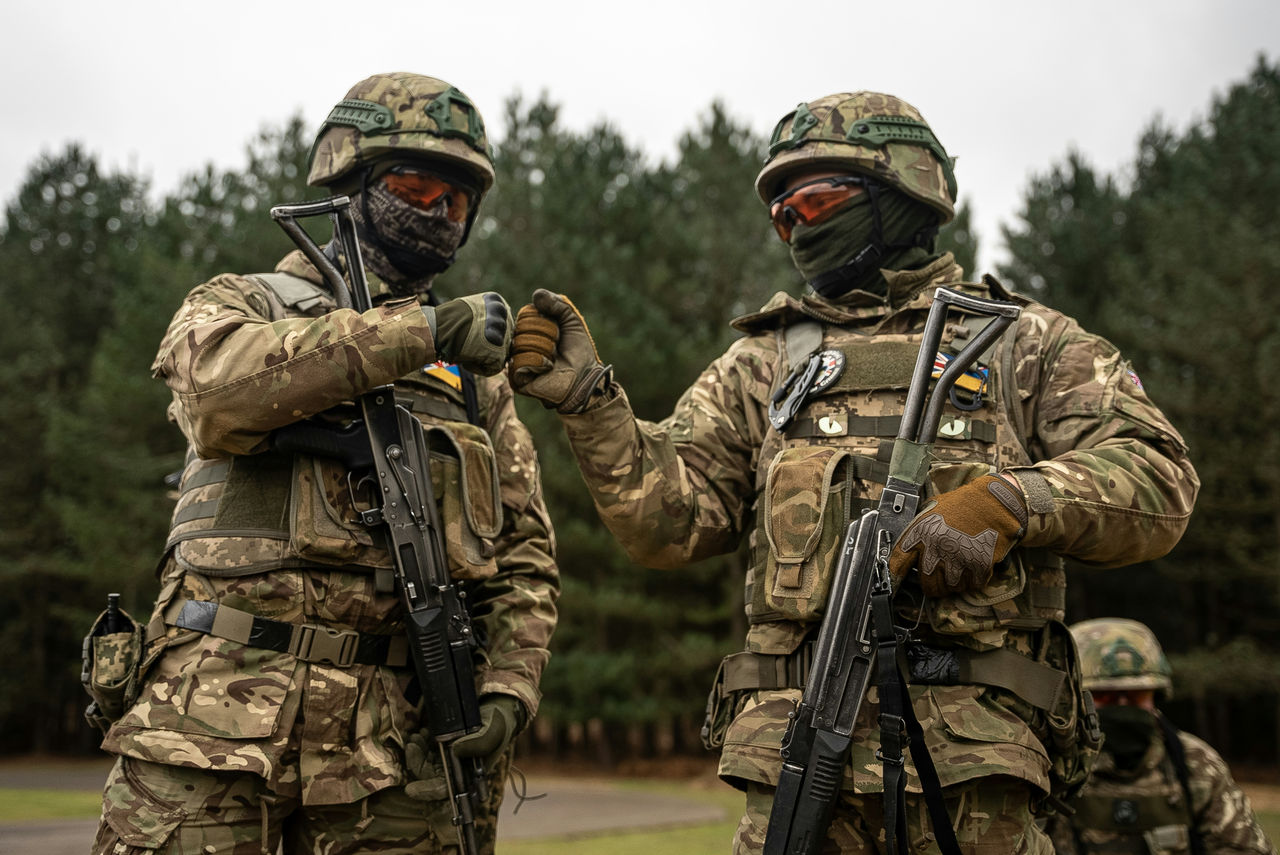 Ukrainian recruits bump fists while waiting to perform live fire drills on a range in the UK. Operation Interflex forms part of the British Army’s contribution to the training of Ukrainian recruits. A five-week programme teaches soldiers the essential skills needed to fight and survive on the frontlines in Ukraine.



Operation Interflex is a multinational effort involving NATO Allies and partner countries providing training at various sites across the United Kingdom and has seen 51,000 recruits trained since summer 2022.

